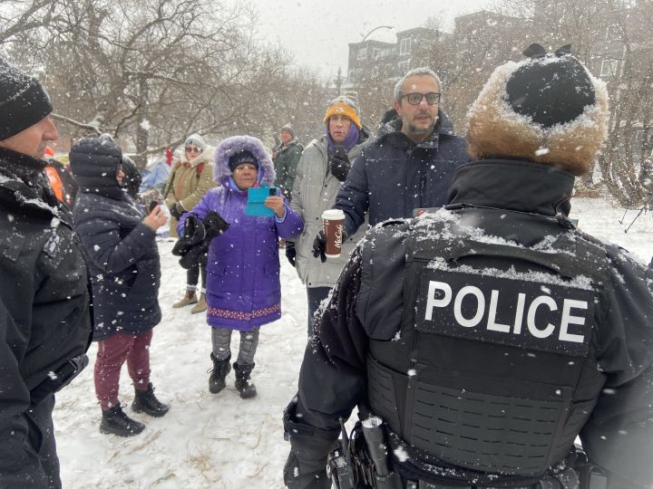 Edmonton police officers and city crews could be seen at a homeless encampment in the area of 95th Street and Rowland Road on Tuesday morning. Police and cleanup crews were met with resistance from people who live in the camp and from advocates who showed up to support them.