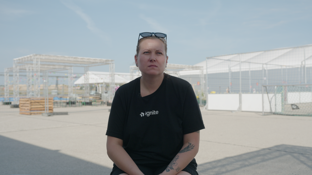 Kateryna sits outside of the Tegel Airport refugee camp in September 2023.