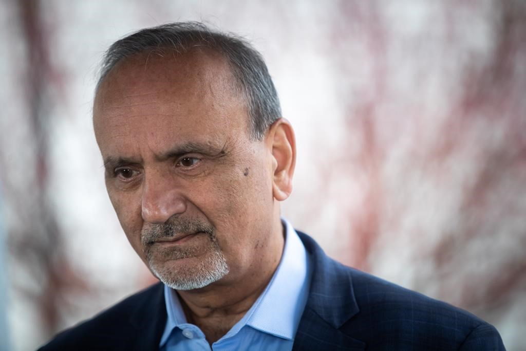 B.C. Labour Minister Harry Bains listens to a question in Surrey, B.C., on Monday, March 14, 2022.