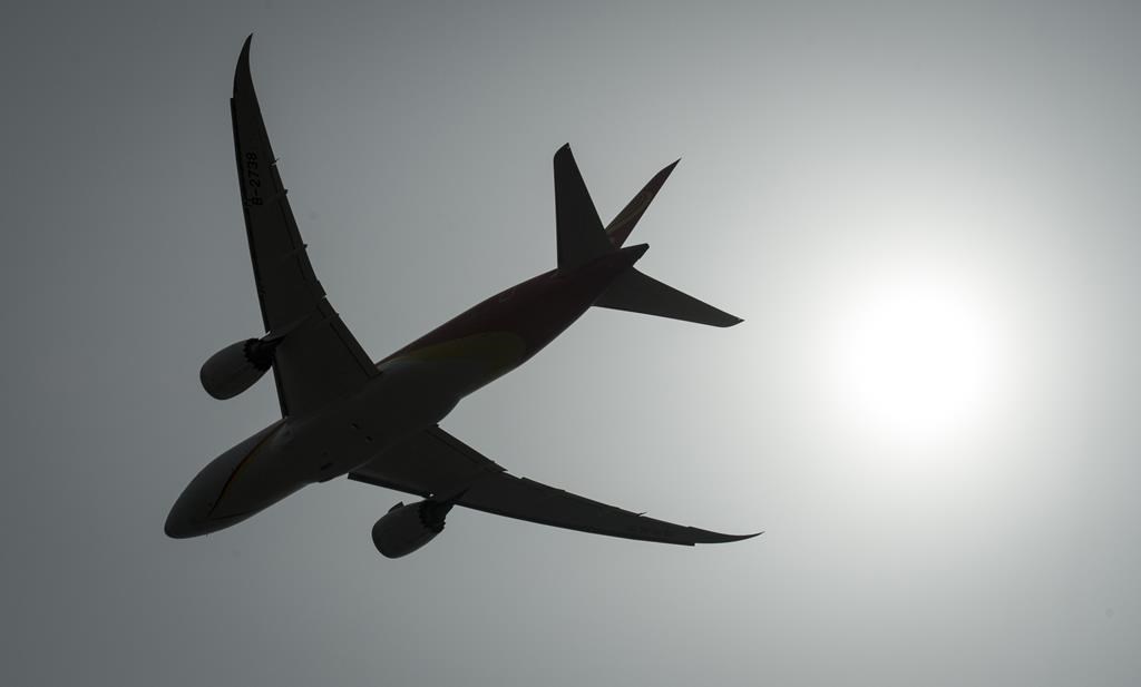 A plane is silhouetted as it takes off.