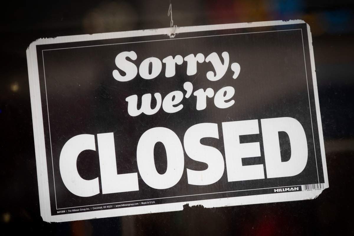 Close-up of a sign that says 'Sorry, we're closed.'