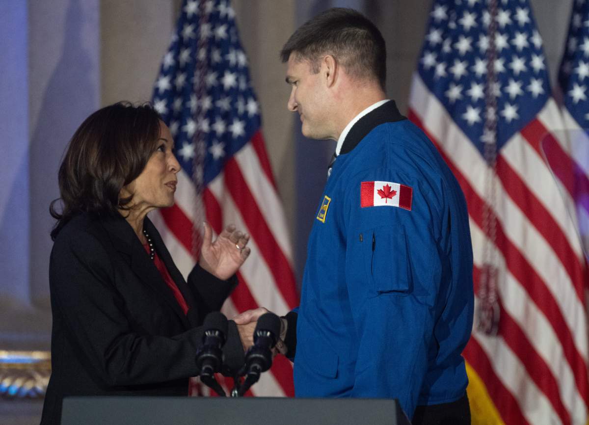 Canadian Space Agency astronaut and Artemis II crew member Jeremy Hansen shakes hands with U.S. Vice-President Kamala Harris.