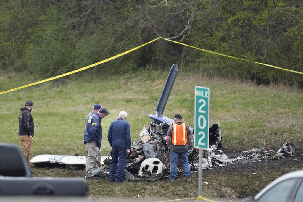 Investigators look over a small plane crash alongside eastbound Interstate 40 at mile marker 202 on Tuesday, March 5, 2024, in Nashville, Tenn. U.S. authorities continue to investigate a plane crash in Tennessee that killed five Canadians.