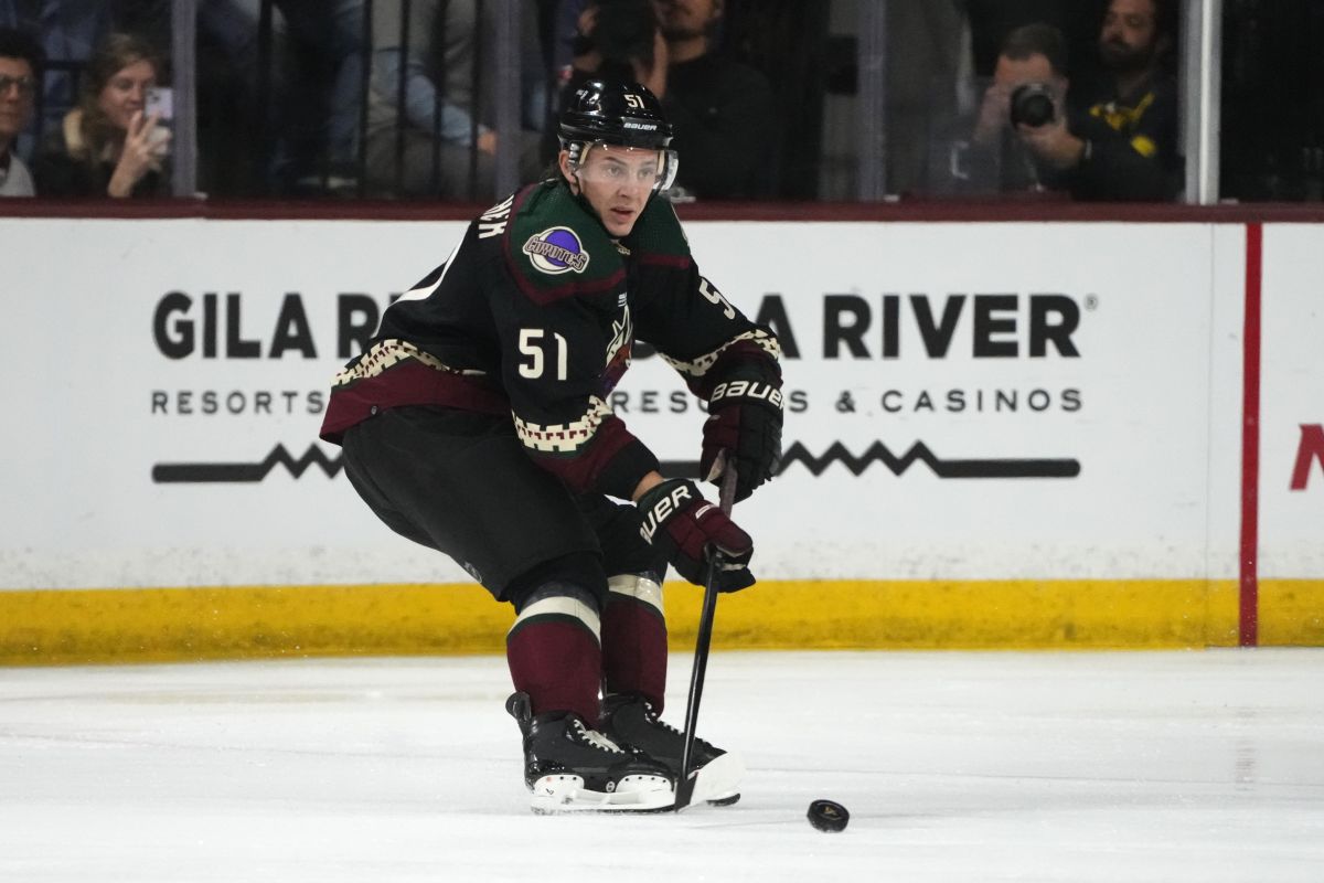 Arizona Coyotes defenceman Troy Stecher skates with the puck against the Buffalo Sabres during the first period of an NHL hockey game Saturday, Dec. 16, 2023, in Tempe, Ariz. The Coyotes won 2-0.