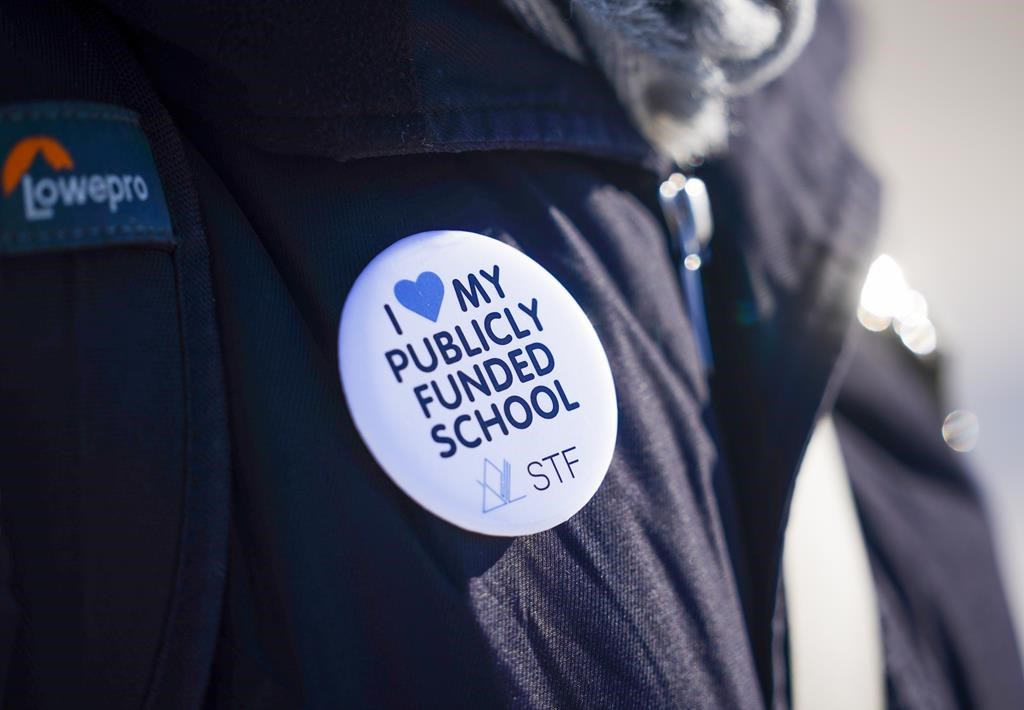 A person wears a Saskatchewan Teachers' Federation button during a provincewide, one-day strike organized by members of the Saskatchewan Teachers' Federation in Saskatoon on Tuesday, Jan. 16, 2024.