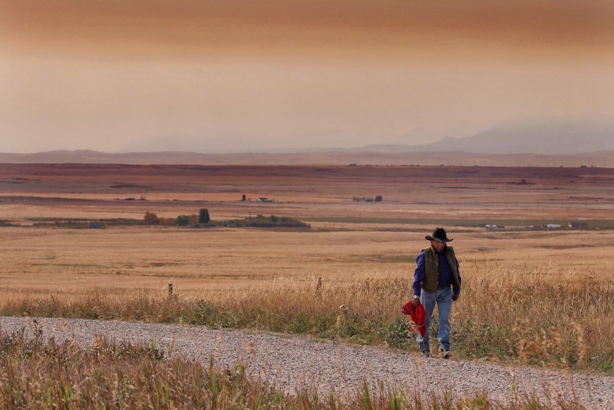 A resident of the Blood Reserve, southeast of Waterton Lakes National Park, Alta., walks down a side road on Tuesday, September 12, 2017.