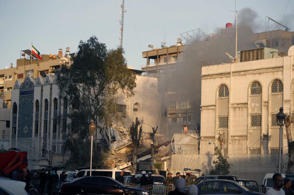 Emergency services work at a destroyed building hit by an air strike in Damascus, Syria, Monday, April 1, 2024. An Israeli airstrike has destroyed the consular section of Iran’s embassy in Damascus, killing or wounding everyone inside, Syrian state media said Monday. (AP Photo/Omar Sanadiki)