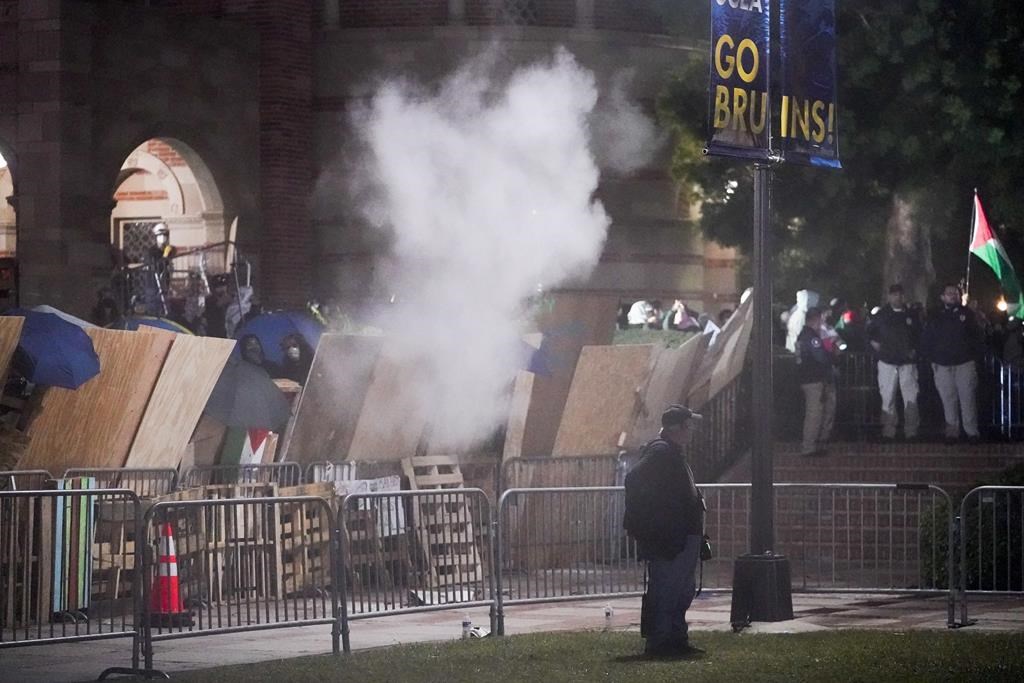 Pro-Palestinian demonstrators stand behind a barrier on the UCLA campus late Wednesday, May 1, 2024, in Los Angeles. (AP Photo/Ryan Sun)
