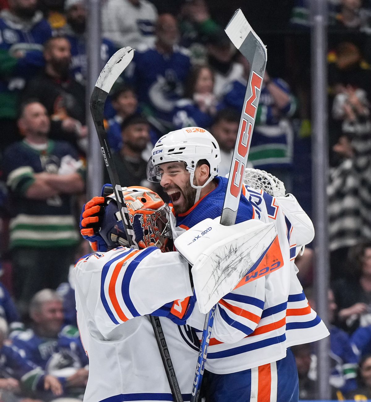 Edmonton Oilers' Evan Bouchard, right, and goalie Stuart Skinner celebrate after Edmonton defeated the Vancouver Canucks 3-2 during Game 7 of an NHL hockey Stanley Cup second-round playoff series, in Vancouver, on Monday, May 20, 2024.