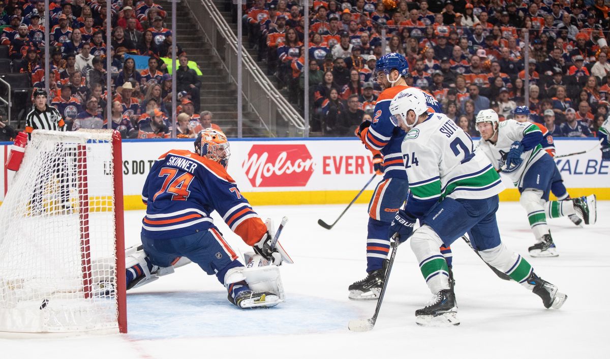 Vancouver Canucks' Pius Suter (24) watches the puck go in the net past Edmonton Oilers goalie Stuart Skinner (74) during first period second-round NHL playoff action in Edmonton on Sunday May 12, 2024.