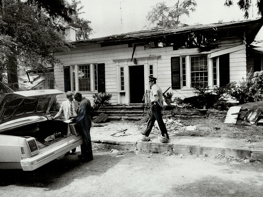 Police and investigators probe the firegutted home of Peter Demeter.
