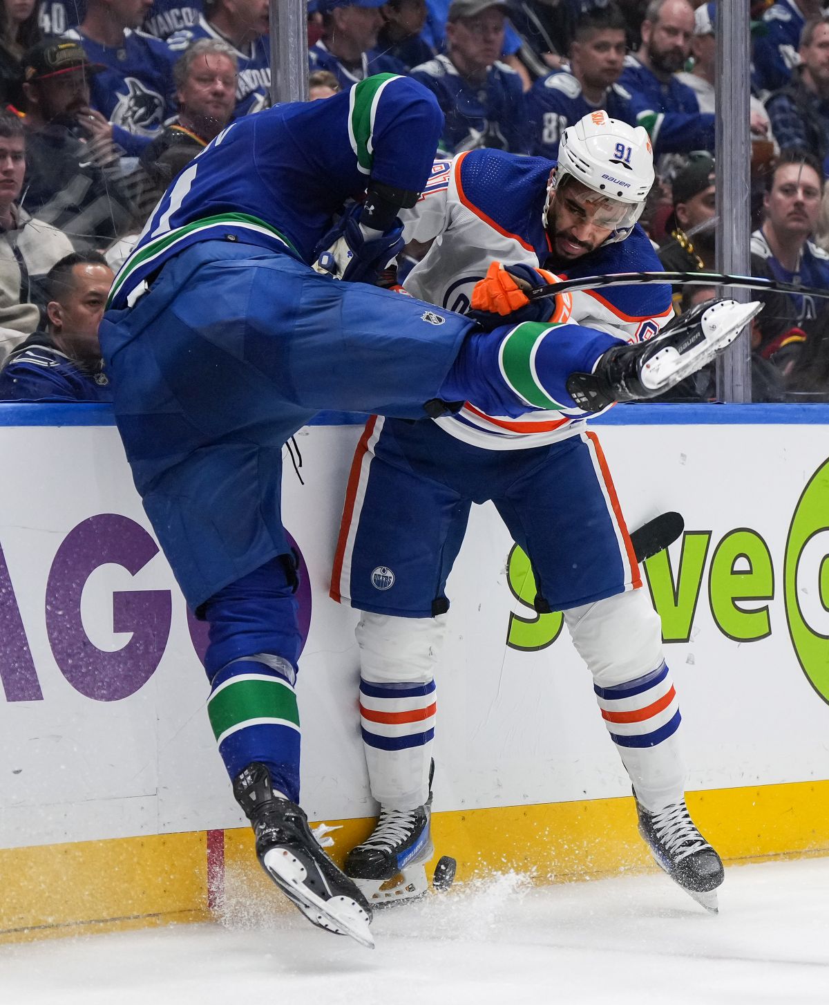 Edmonton Oilers' Evander Kane, back right, checks Vancouver Canucks' Nikita Zadorov during the second period in Game 7 of an NHL hockey Stanley Cup second-round playoff series, in Vancouver, on Monday, May 20, 2024.