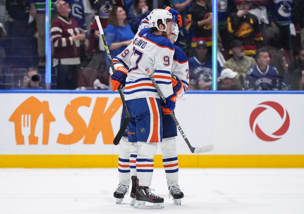 Edmonton Oilers' Connor McDavid, front, and Leon Draisaitl celebrate after Edmonton defeated the Vancouver Canucks 3-2 during Game 7 of an NHL hockey Stanley Cup second-round playoff series, in Vancouver, on Monday, May 20, 2024.