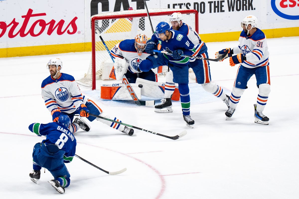 Edmonton Oilers goalie Stuart Skinner (74) stops Vancouver Canucks' Conor Garland's shot, as Evan Bouchard (2), Mattias Ekholm (14), Evander Kane (91), and Vancouver's Dakota Joshua (81) watches during the second period in Game 7 of an NHL hockey Stanley Cup second-round playoff series, in Vancouver, on Monday, May 20, 2024.