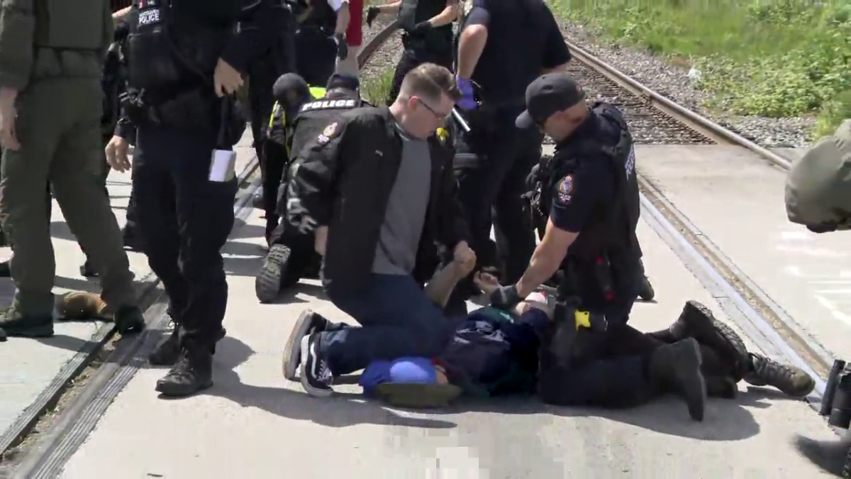 Vancouver police make an arrest at a protest blocking a rail line in East Vancouver on Friday, May 31, 2024. 