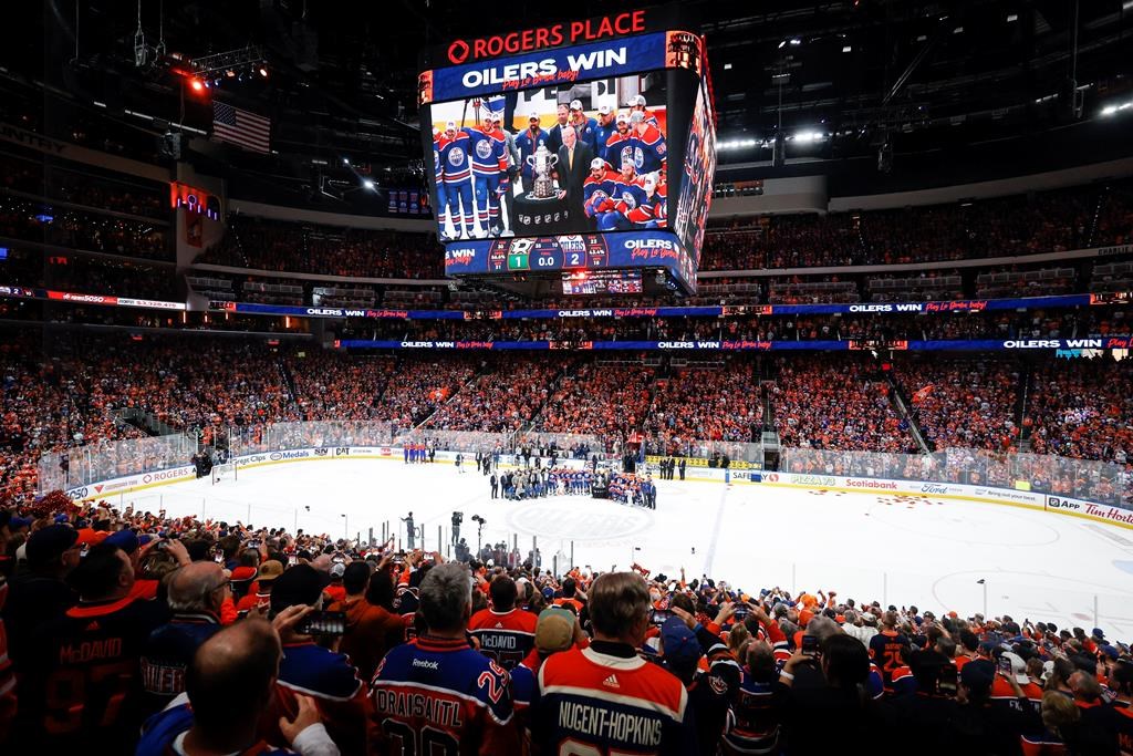 The Edmonton Oilers pose with the trophy after defeating the Dallas Stars in Game 6 of the Western Conference finals of the NHL hockey Stanley Cup playoffs in Edmonton, Sunday, June 2, 2024.