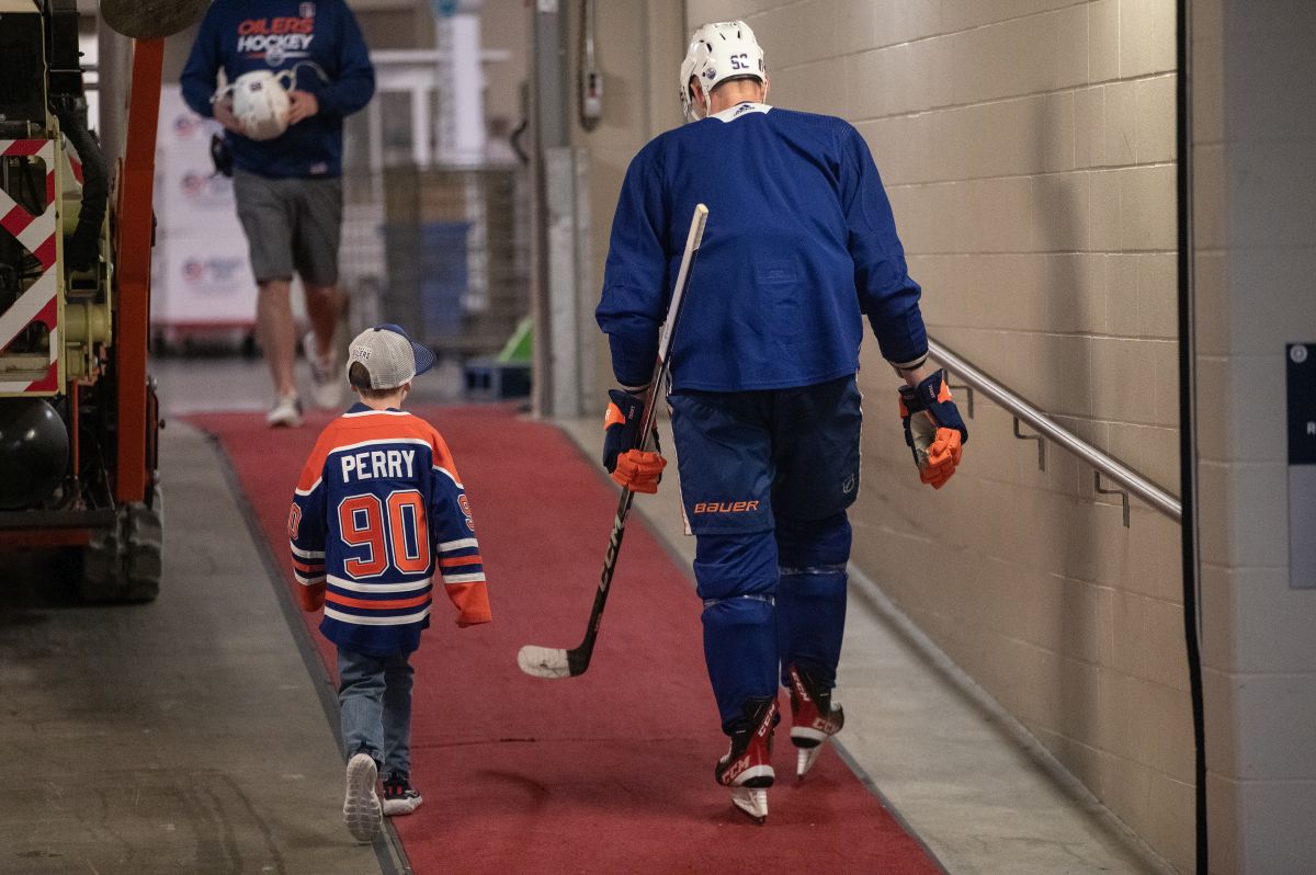 Edmonton Oilers' Corey Perry (90) and his son Griffen walk together after practice before the Oilers take on the Florida Panthers in the NHL Stanley Cup playoffs, in Edmonton, Wednesday, June 5, 2024.