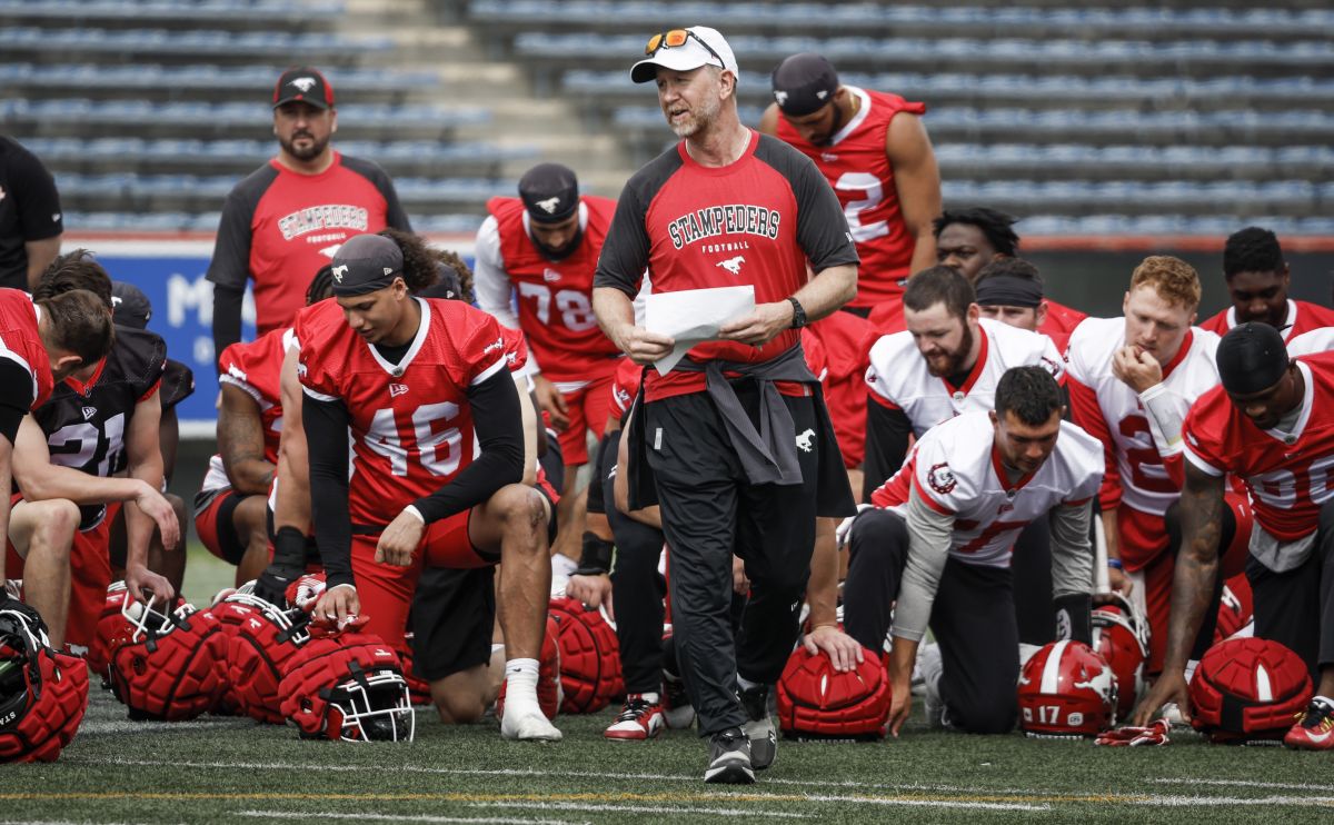 Calgary Stampeders head coach Dave Dickenson, centre right, speaks to players during opening day of training camp in Calgary, Alta., Sunday, May 12, 2024.