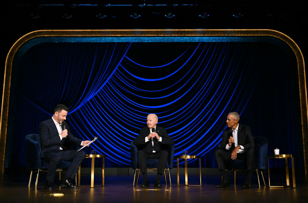 U.S. President Joe Biden (C) speaks, flanked by television host Jimmy Kimmel (L) and former President Barack Obama, onstage during a campaign fundraiser at the Peacock Theater in Los Angeles on June 15, 2024.