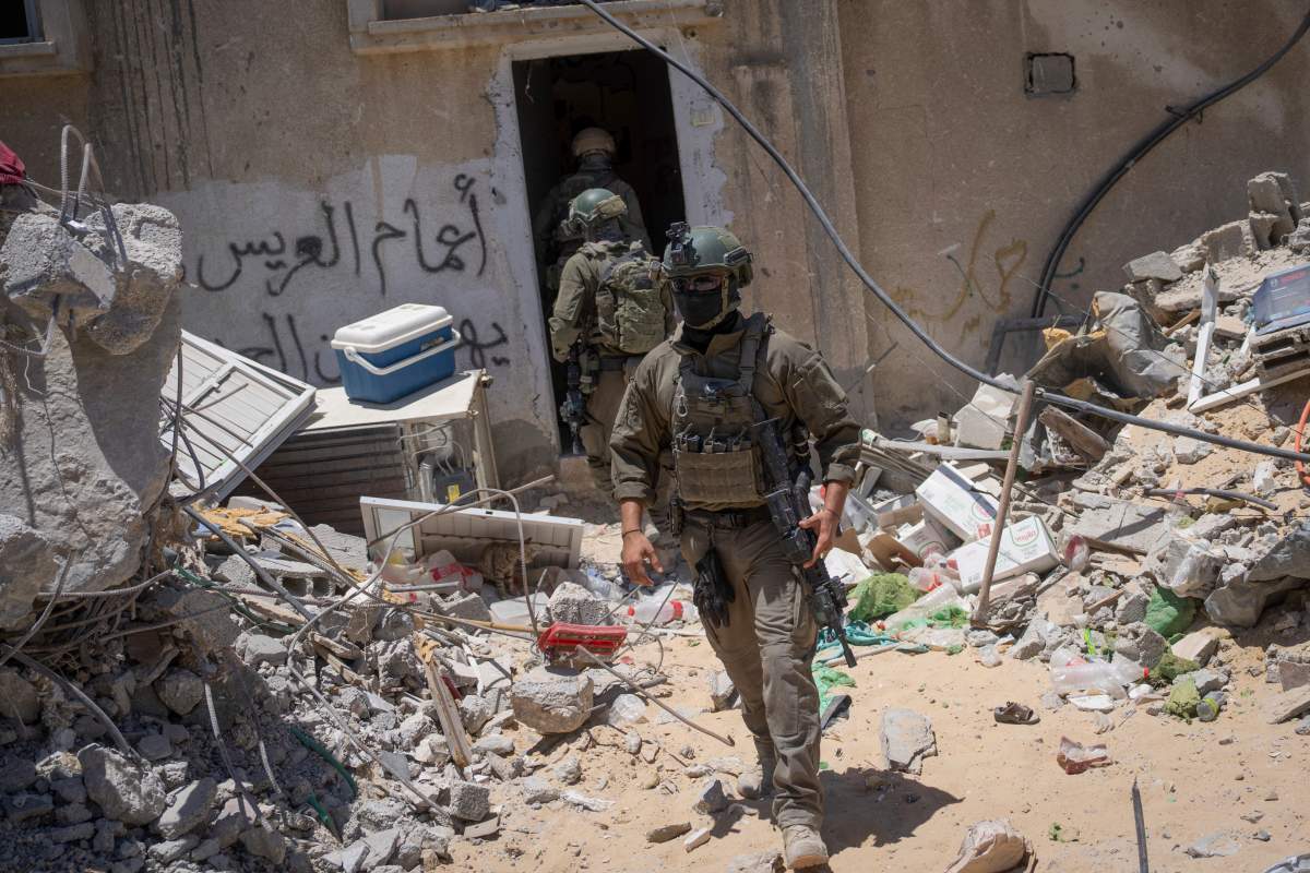 Israeli soldiers walk in the southern Gaza Strip, Wednesday, July 3, 2024. The Israeli military invited reporters for a tour of Rafah, where the military has been operating since May 6. (AP Photo/Ohad Zwigenberg, Pool)