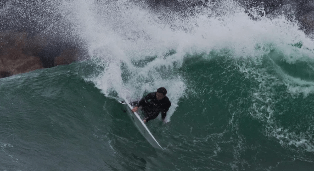 Kai McKenzie surfing a wave. The 23-year-old surfer was attacked by a shark who bit off his right leg on July 23, 2024.