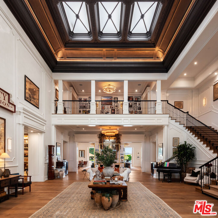 Two-storey entryway with an exposed view of the second floor and a wrap-around staircase.