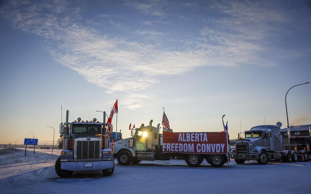 A truck convoy of anti-COVID-19 vaccine mandate demonstrators block the highway at the busy U.S. border crossing in Coutts, Alta. on Wednesday, Feb. 2, 2022.