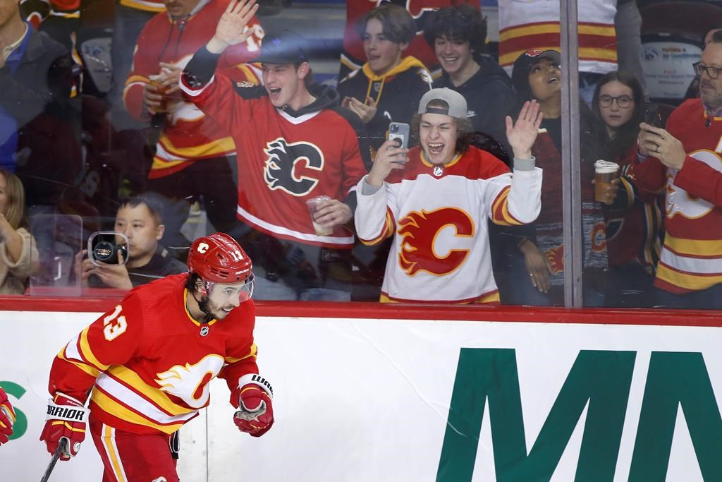 Calgary Flames left wing Johnny Gaudreau celebrates his 100th season point, an assist, during NHL hockey action against the Seattle Kraken in Calgary on April 12, 2022.