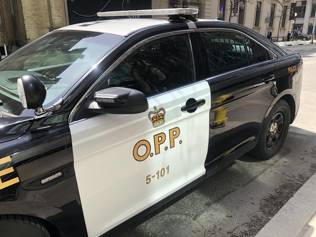 An Ontario Provincial Police vehicle sits idle in downtown Toronto on April 11, 2023. An Ontario Provincial Police finding that there was no "serious" officer misconduct after a police car struck and killed a pedestrian has been thrown out in court. 