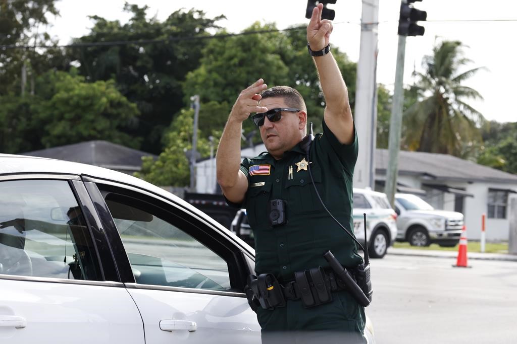 A police officer directs traffic near Trump International Golf Club after the apparent assassination attempt of Republican presidential nominee former President Donald Trump in West Palm Beach, Fla., Sunday, Sept. 15, 2024.