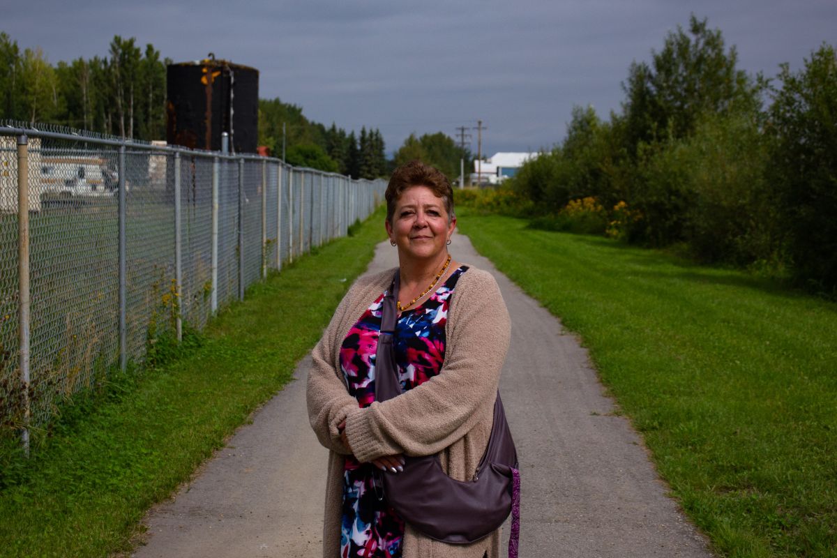 Lynn Bowes, a resident of Slave Lake, Alta., poses for a portrait at a trail near a shuttered homeless shelter on Thursday, Aug. 22, 2024. She is one of many who called on the town to close the shelter due to a perceived spike in crime.