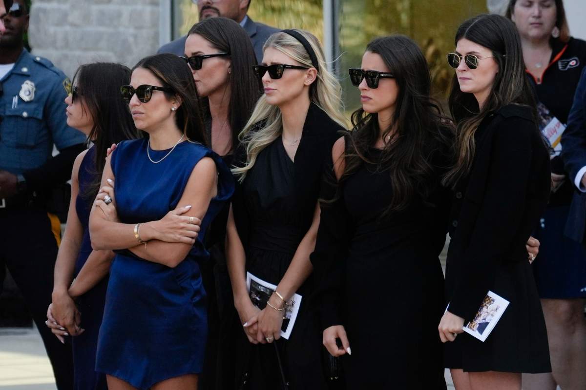 Mourners including, Meredith Gaudreau, second from left, watch as the remains of Columbus Blue Jackets hockey player John Gaudreau and his brother Matthew Gaudreau depart following their funeral at St. Mary Magdalen Catholic Church in Media, Pa., Monday, Sept. 9, 2024.