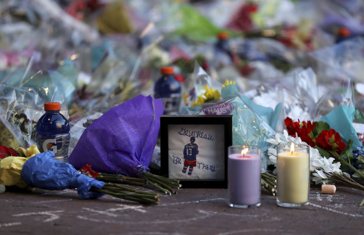 Fans leave mementos as part of the candlelight vigil to honour Columbus Blue Jackets hockey player Johnny Gaudreau, Wednesday, Sept. 4, 2024, outside of Nationwide Arena in Columbus, Ohio. Gaudreau and his brother Matthew were killed by a motor vehicle last week while riding bicycles.