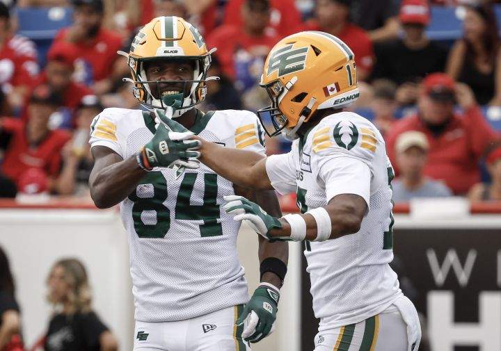 Edmonton Elks' Tevin Jones (84) celebrates his touchdown with Dillon Mitchell (17) during second half CFL football action in Calgary, Monday, Sept. 2, 2024.