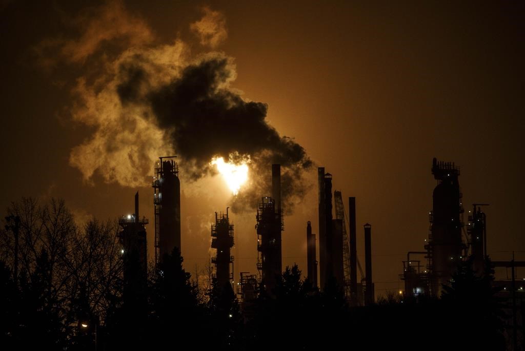 A flare stack lights the sky from an oil refinery in Edmonton on Dec. 28, 2018.