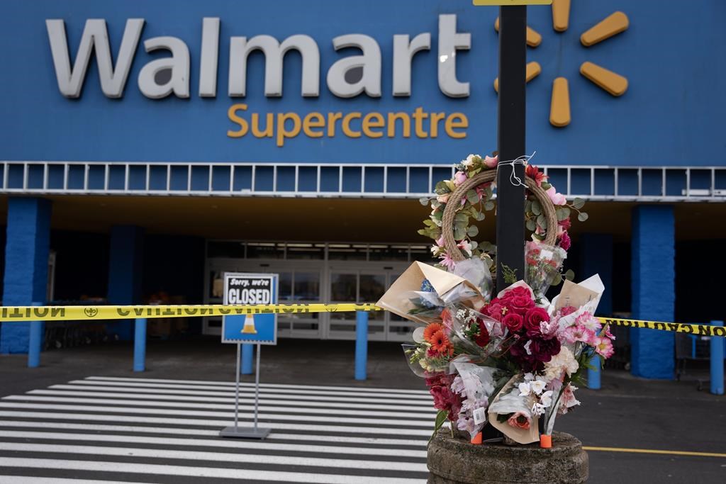 A Walmart remains closed as a vigil grows outside the taped-off area in Halifax on Wednesday, Oct. 23, 2024 following the death of a 19-year-old employee last weekend.  THE CANADIAN PRESS/Darren Calabrese