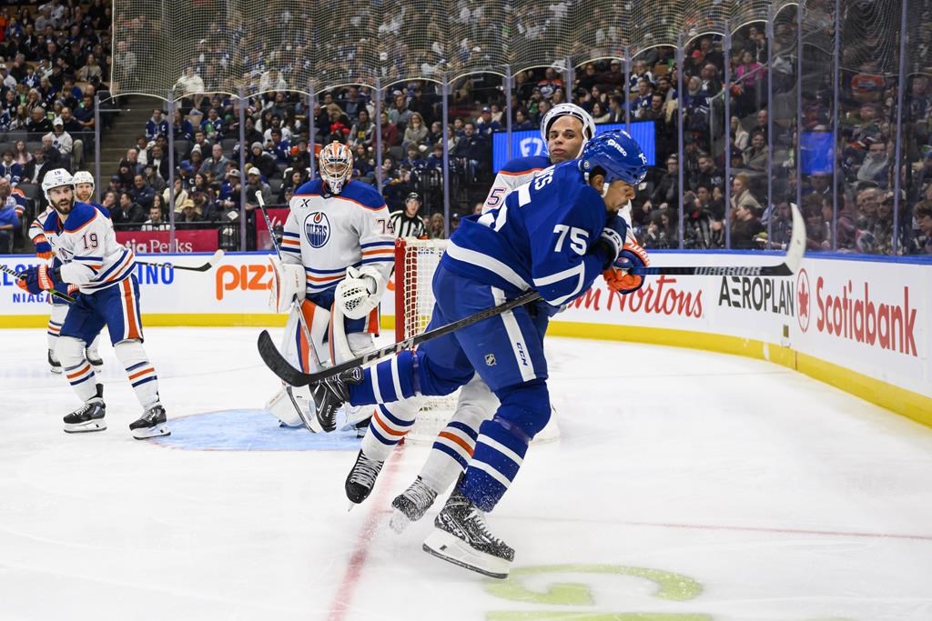 Toronto Maple Leafs right wing Ryan Reaves (75) collides with Edmonton Oilers defenceman Darnell Nurse (25) during second period NHL hockey action, in Toronto, Saturday, Nov. 16, 2024.