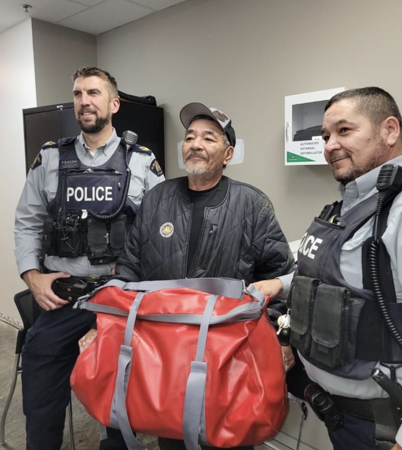 Wilson Moore is honoured for his life's dedication to search and recovery volunteer work in northern Manitoba. Sgt. Andrew I'Anson (left) and S/Cst. Ryan Wrightson presented him with $1000 worth of new search equipment earlier this week.