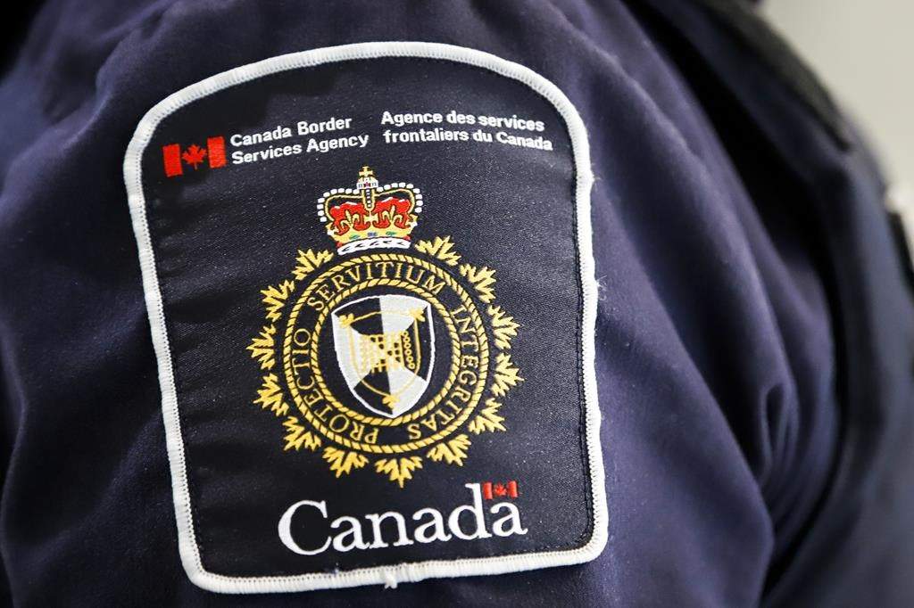 A Canada Border Services Agency (CBSA) patch is seen on an officer in Calgary on Thursday, Aug. 1, 2019. THE CANADIAN PRESS/Jeff McIntosh.