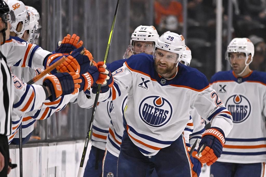 Edmonton Oilers centre Leon Draisaitl (29) celebrates with teammates after scoring against the Anaheim Ducks during the second period of an NHL hockey game in Anaheim, Calif., Sunday, Dec. 29, 2024.