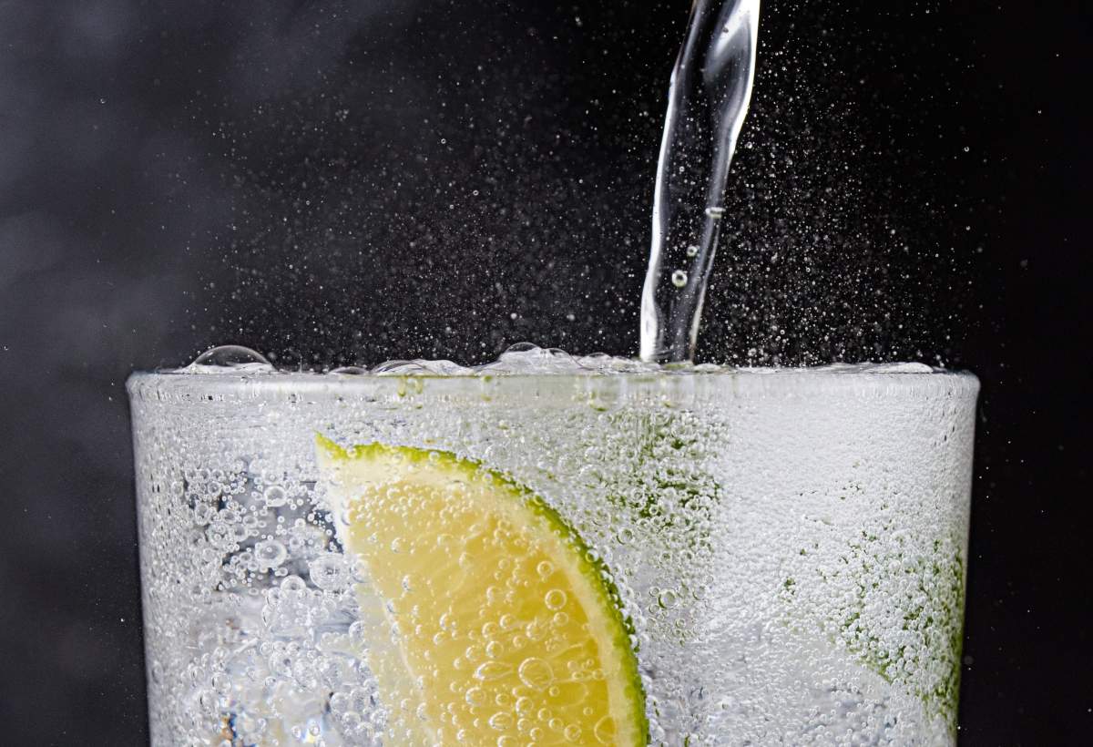 Gin and tonic with ice and lime.