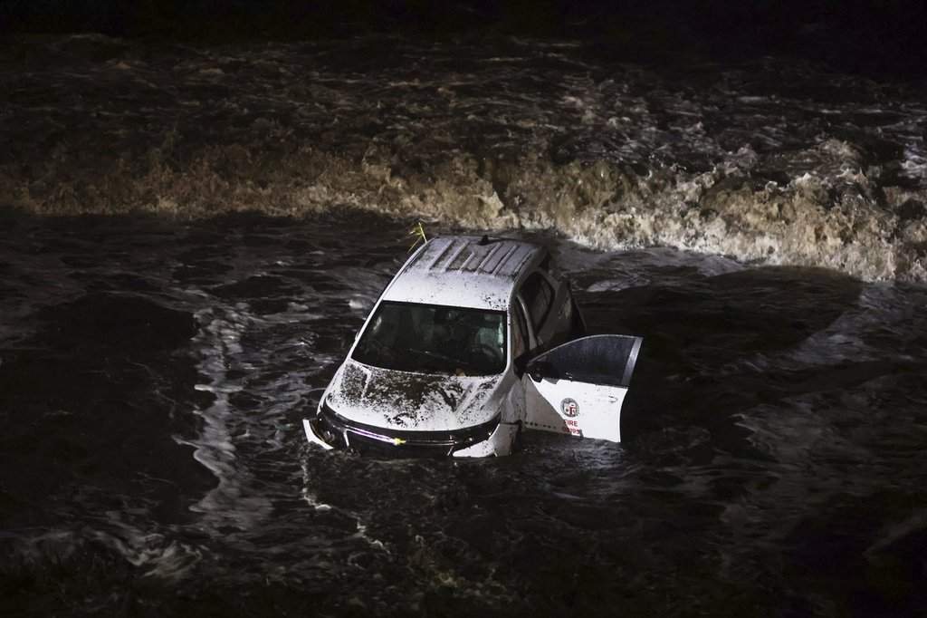An emergency vehicle is hit by surf after being pushed into the ocean during a storm in the Palisades Fire zone Thursday, Feb. 13, 2025, in Malibu, Calif.