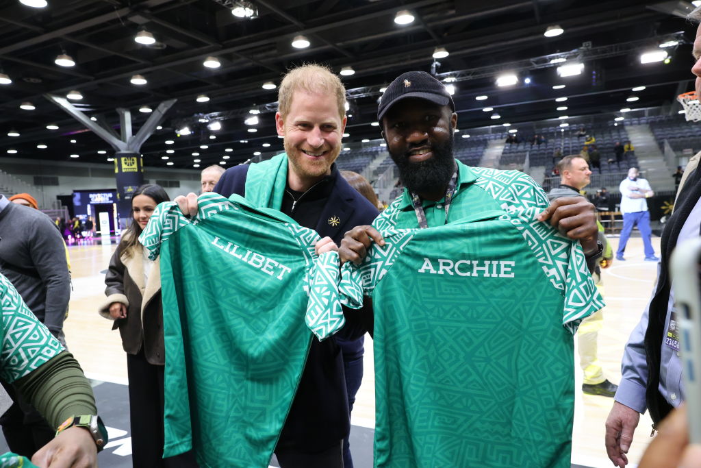 Prince Harry, Duke of Sussex poses with a member of Team Nigeria at the USA vs. Nigeria Wheelchair Basketball Pool Play at Vancouver Convention Centre on Feb. 9, 2025 in Vancouver, British Columbia.
