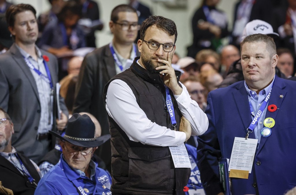 David Parker, centre, founder of Take Back Alberta, looks on as delegates debate resolutions at the United Conservative Party annual general meeting in Calgary, Alta., on Sat., Nov. 4, 2023. THE CANADIAN PRESS/Jeff McIntosh.