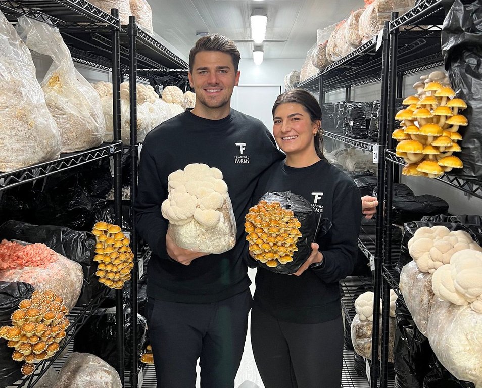 Cavalry FC midfielder Charlie Trafford and his sister Sya Trafford, co-founders of Trafford Farms show off some of the mushrooms they produce in this handout image.
