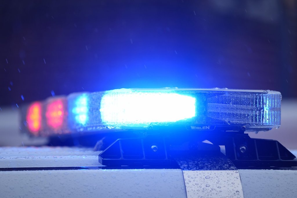 Lights on a parked police vehicle flash.
