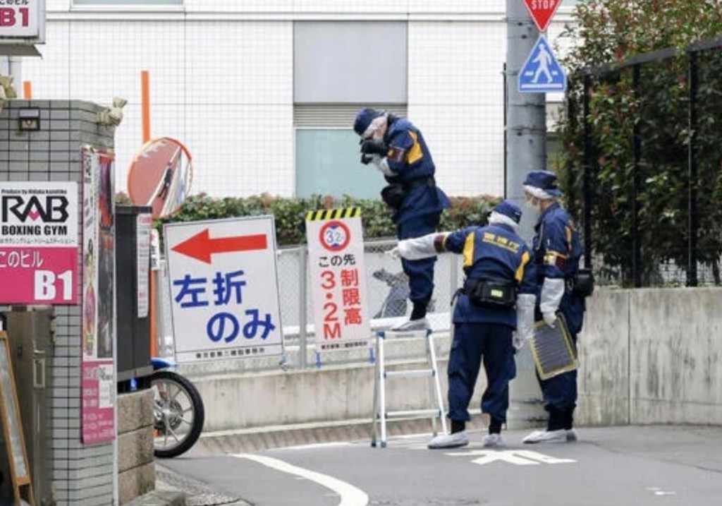 Japanese police investigators work near the scene of a stabbing of a woman in the Shinjuku district of Tokyo, Tuesday, March 11, 2025.