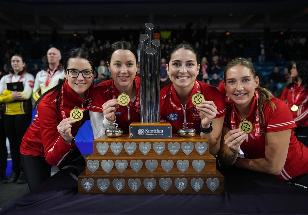 Team Canada skip Kerri Einarson, from left to right, third Val Sweeting, second Shannon Birchard and lead Briane Harris pose with their gold medals and the trophy after defeating Manitoba in the final at the Scotties Tournament of Hearts in Kamloops, B.C., on Sunday, February 26, 2023.