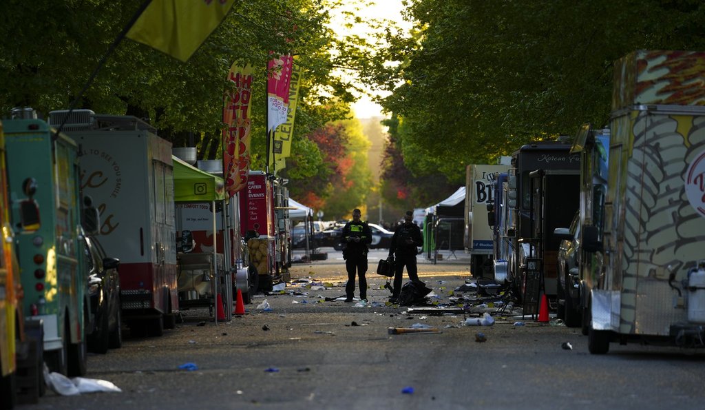 Members of the Vancouver Police forensics team examine the scene where a vehicle drove into a crowd at a Lapu Lapu Day street festival Saturday evening in Vancouver, Sunday, April 27, 2025.
