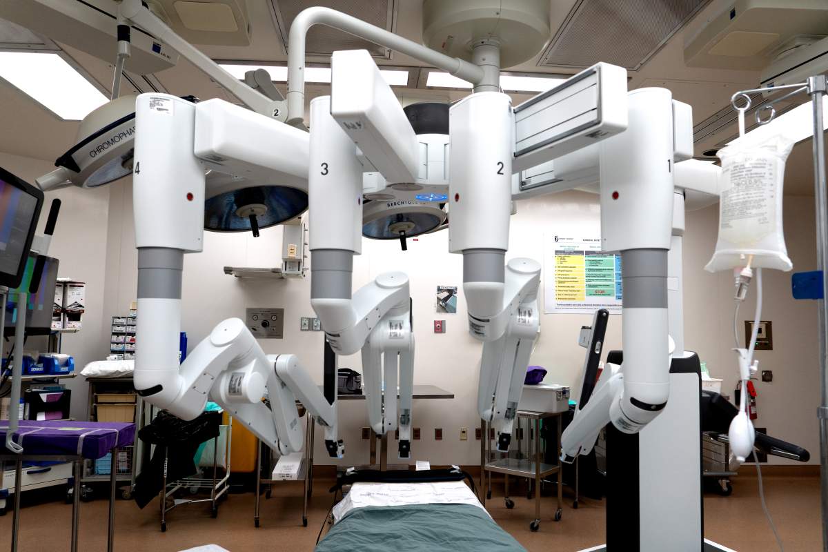 A wide shot of the da Vinci xi. The robot has 4 arms that can be controlled via a console and provides feedback to the user.